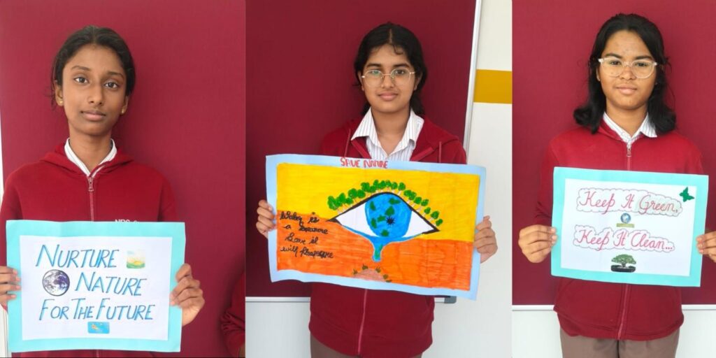 Students proudly hold handmade environmental awareness posters during the World Environment Day celebration at school.