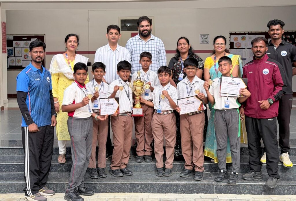 NPS OMR Grade 5 football team with the championship trophy after winning the Dasha Sambrama tournament
